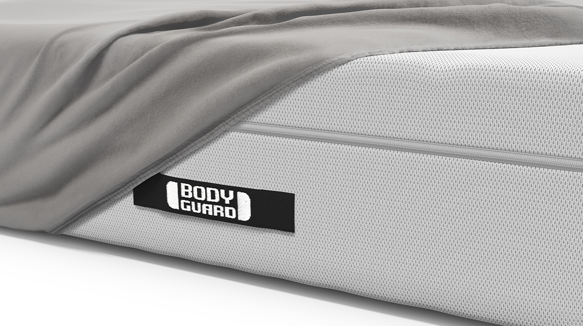 Le drap-housse en Jersey Bodyguard couvrant une parytie du matelas BODYGUARD Boxspring