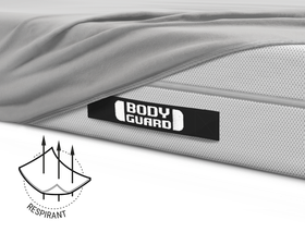 La moitié du matelas BODYGUARD® est recouverte du drap-housse en jersey gris. Illustration du tissu avec trois flèches qui le traversent. Texte : respirant