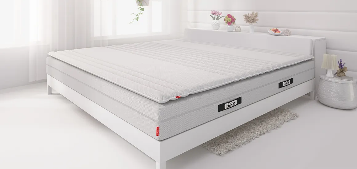 Matelas Bodyguard Boxspring avec un surmatelas  Bodyguard dans un lit