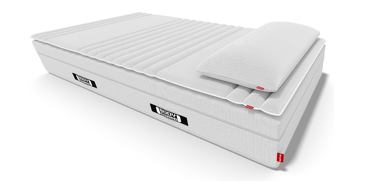 Matelas Bodyguard avec un surmatelas posé dessus.